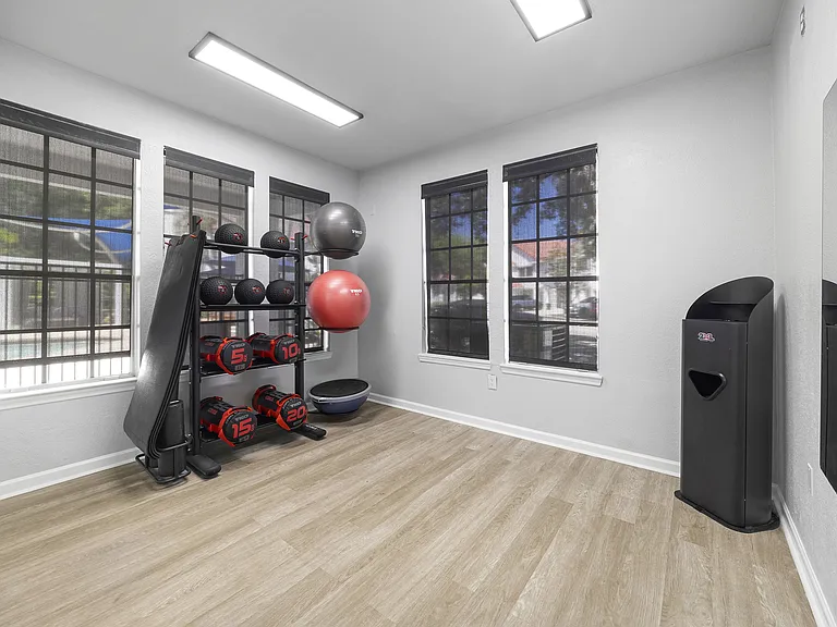 Bright weight room with free weights and medicine balls for focused strength sessions