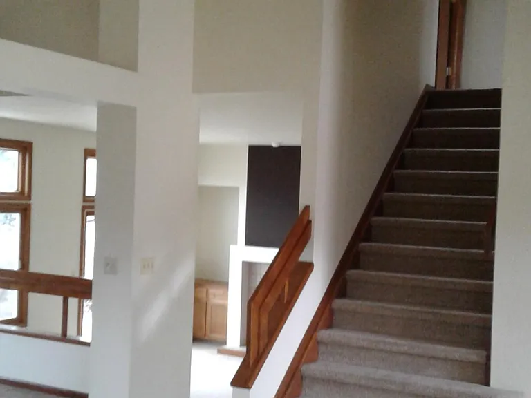 Lots of windows in family room with a fireplace.
