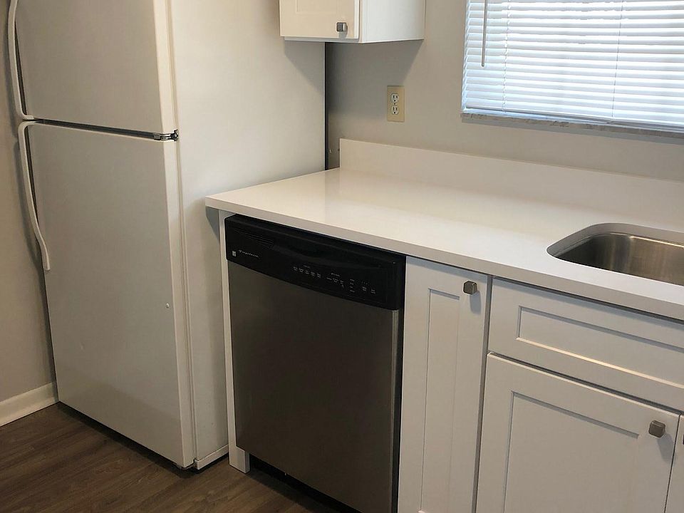 Remodeled kitchen quartz countertops. ice maker, stainless steel sink and dishwasher, stove