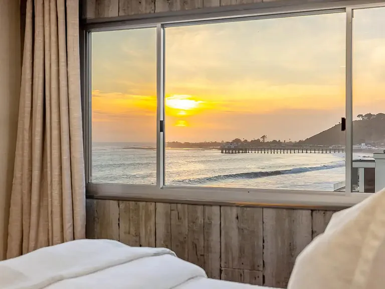 Wind down in the bedroom, where sunset hues set the mood for a peaceful evening.