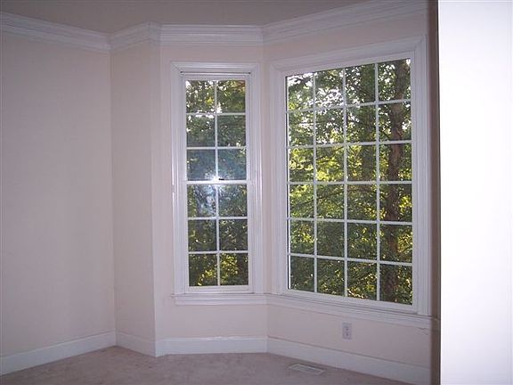 Formal sitting room with bay windows looking out over private lot