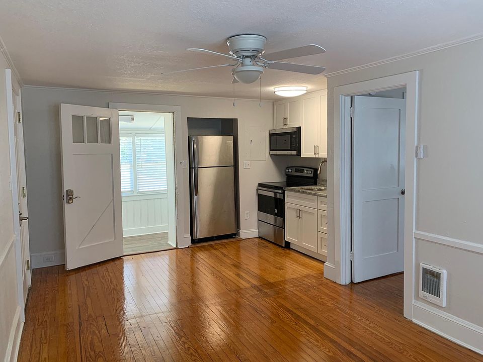 Living area showing renovated kitchen area, dining area and sunroom leading to the back deck