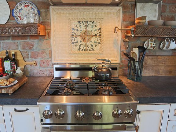 Custom tile work and beautiful open shelving.