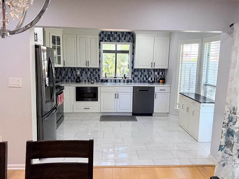 The completely renovated kitchen is connected to the dining area.