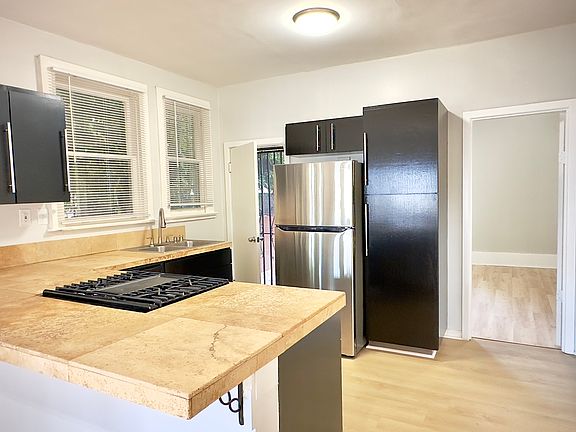 Kitchen view. All granite countertops and new stainless steel appliances.