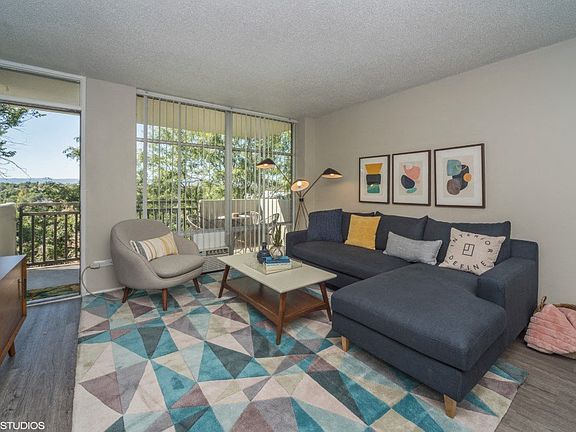 Spacious living room with natural lighting and balcony access