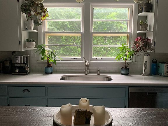 Beautiful kitchen with stainless steel appliances and quartz countertops.