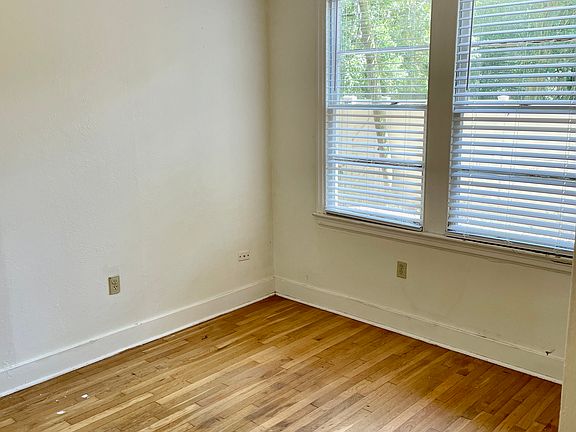 Side bedroom with hardwood floors and closet.