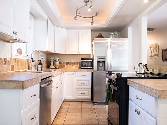 Modern and open kitchen with dishwasher and brand new pull down faucet.