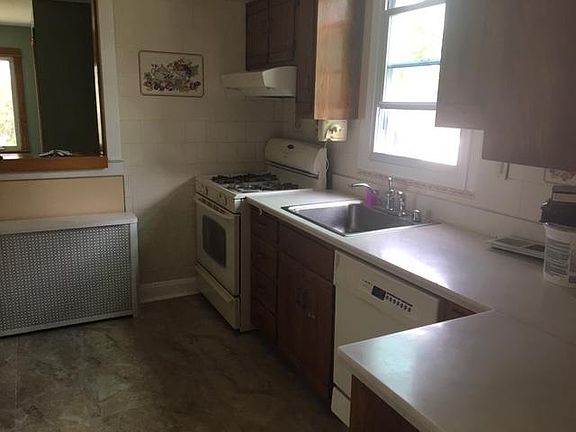 Kitchen including appliances and newly tiled floor