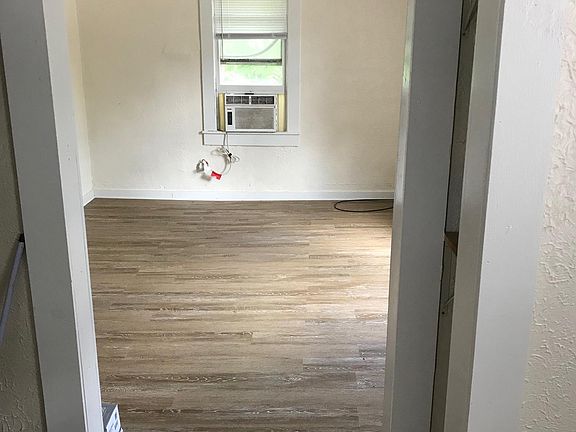 Bedroom and bathroom entrance off of main living area with kitchenette.
