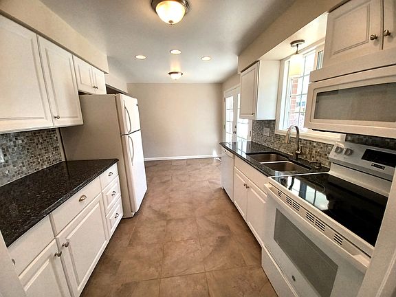 Updated Galley Kitchen with dining space in front of the french doors to the backyard