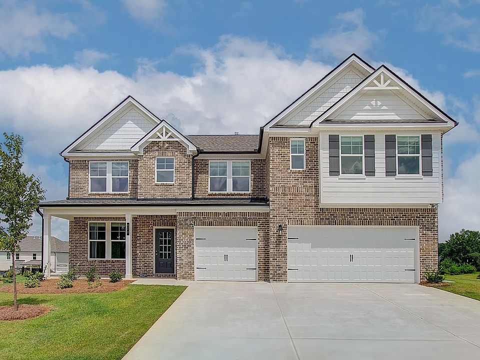 Rosemary II 4-sided brick home with siding accent and three car front-entry garage at Westwind Estat