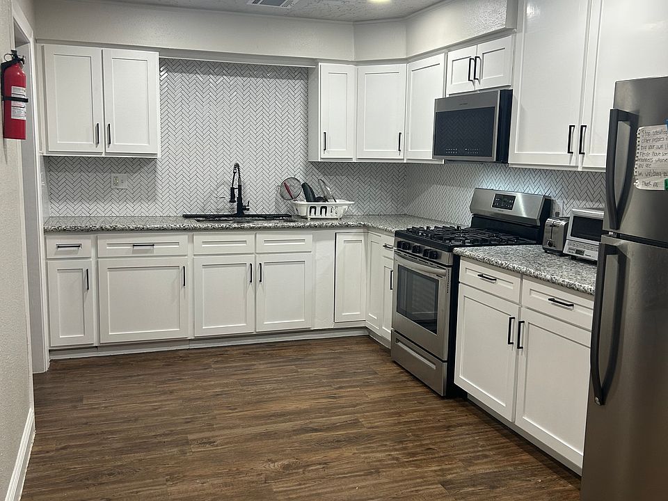 Main refrigerator in kitchen and mini refrigerators in each room.