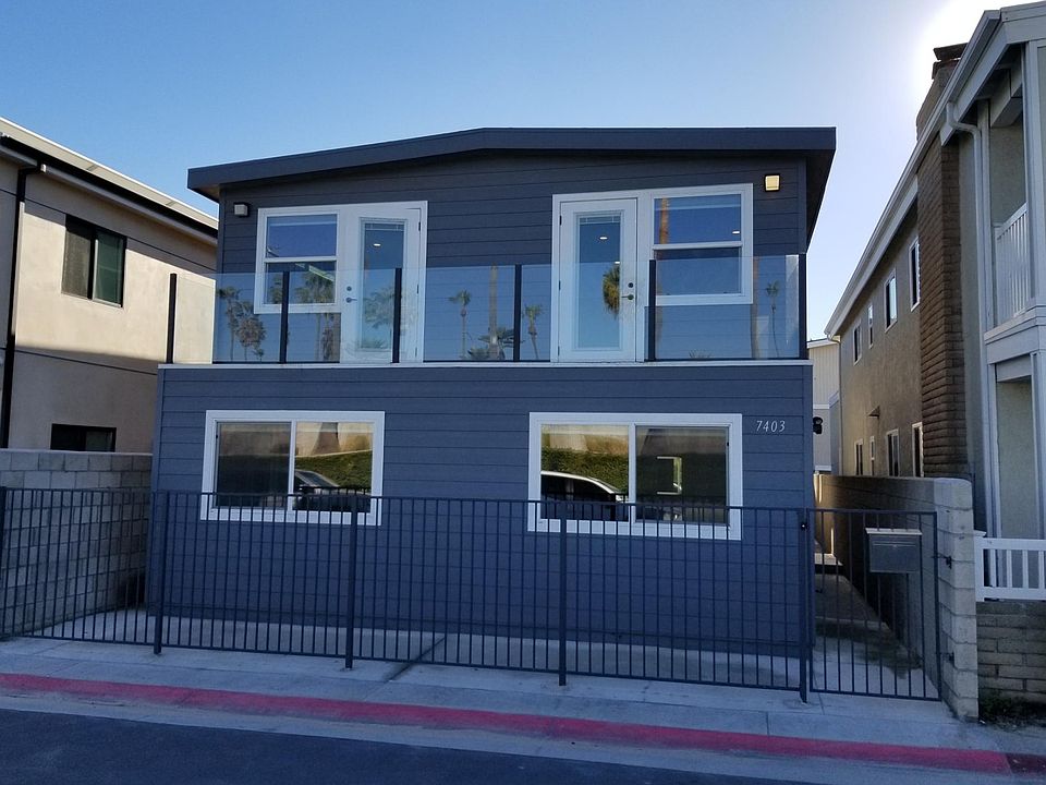 Home as seen from Seashore Drive. Each window seen here denotes a separate bedroom, upstairs each room has a door leading to the upstairs balcony. Enter the gate on right side and half way down side-yard you'll find the front door.