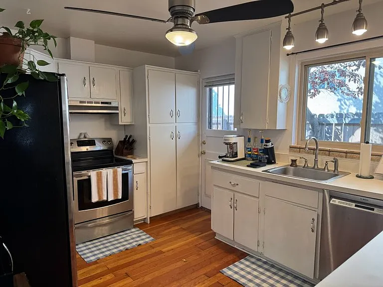 Kitchen with newer stainless steel appliances & recently painted. Lockable dog door to north side of house.