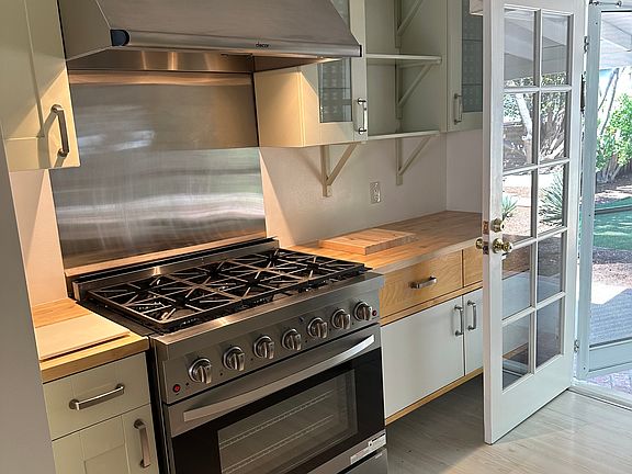 Custom kitchen - Commercial grade range...custom cabinets...butcher block countertop