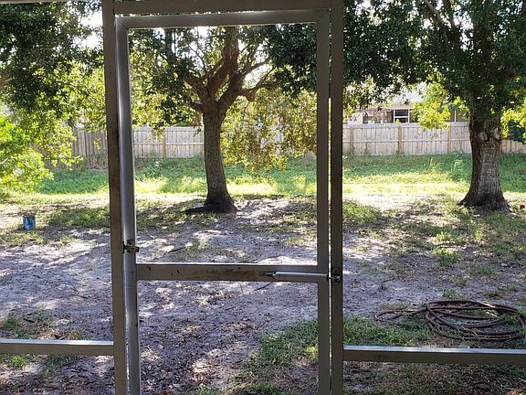Back yard, overlooks small canal. Shady oaks.