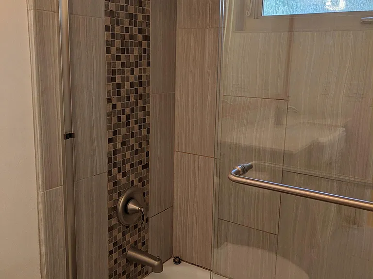 Shared bathroom also features custom tilework.