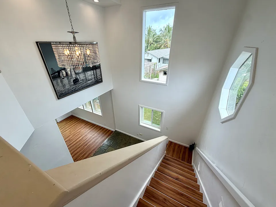 Downstairs view of the stairs, peeping into the living room