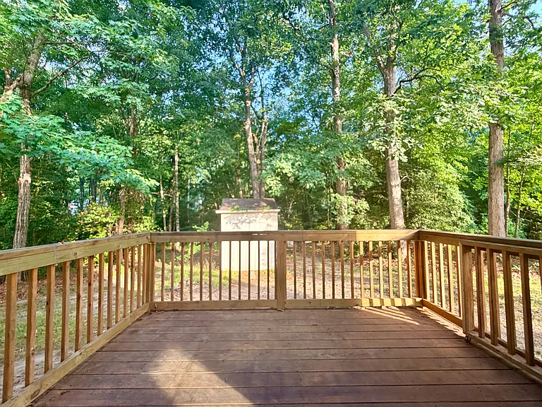 Private back deck, right off of kitchen, overlooking property