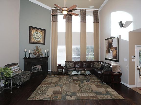 The main living area has soaring ceilings, anchored by a cozy fireplace.