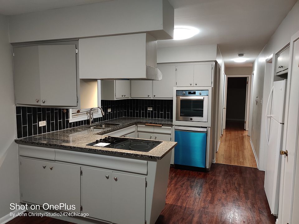 Kitchen looking from dining area - New oven and dishwasher (protective blue plastic still on dishwasher)