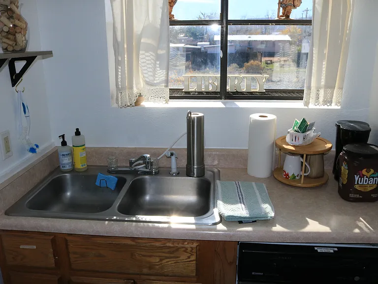 kitchen sink and window to front. sink has a water filter for drinking water