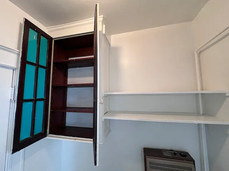 Additional storage space for the kitchen or closet. Also featuring a wall hung heater.