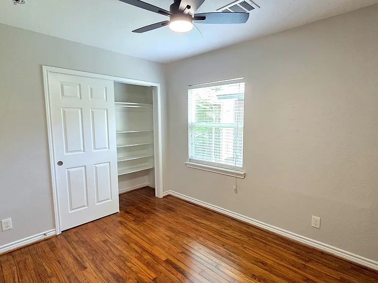 Enjoy the comfort in this secondary bedroom that offers shelves in the closet and beautiful hardwood floors.