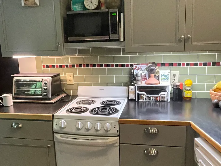 A lot of kitchen for a studio apartment.