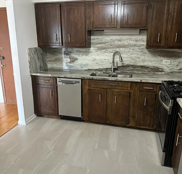 Gorgeous custom granite counter top and granite backsplash with built-in dishwasher.