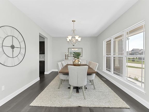 Dining room is spacious and bright.  Plenty of space for a large 10 seat table and buffet.  Door on left leads to the awesome kitchen!
