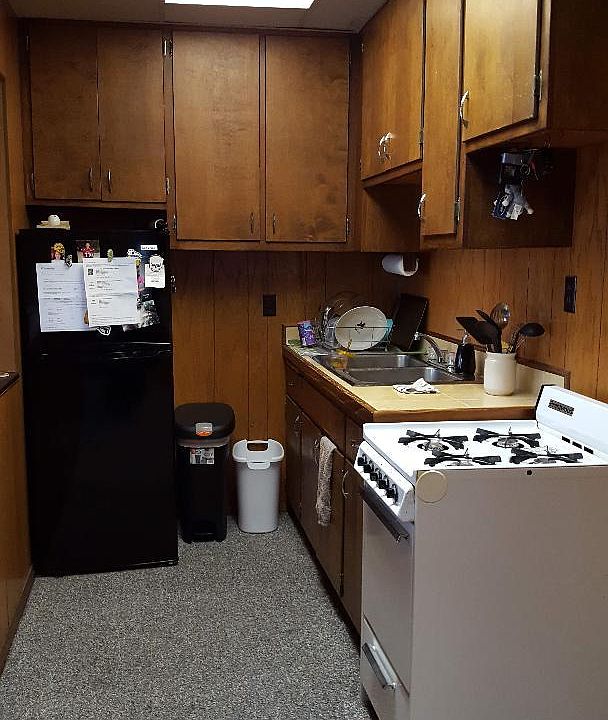 View of kitchen bathroom entrance to right, living room entrance to left