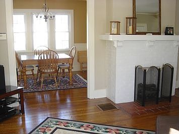 Looking through Living Room with Fireplace into Dining Room