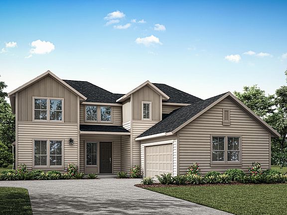 A two-story residential house with a gabled roof, siding, and a well-manicured lawn surrounded by tr