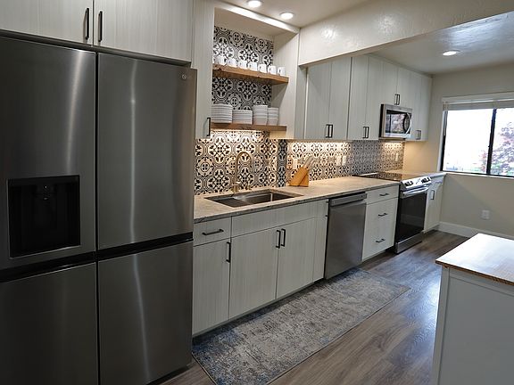 New high-end appliances, oversized sink, refrigerator, dishwasher, garbage disposal, range, microwave.