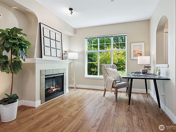 Living and dining areas with a cozy fireplace that adds the perfect ambiance.>