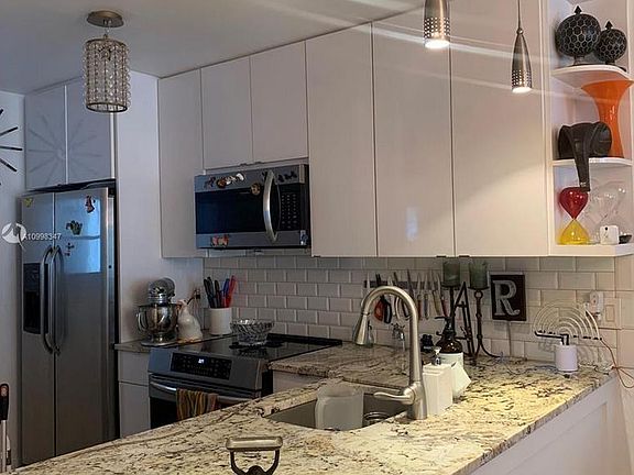 MORE KITCHEN UPGRADES - Waterfall edge granite countertops, pull-out cutlery and pot drawers and stainless steel appliances with FULL-SIZED refrigerator (many units have smaller apartment-sized ones), induction cooktop and oven with built-in air fryer.