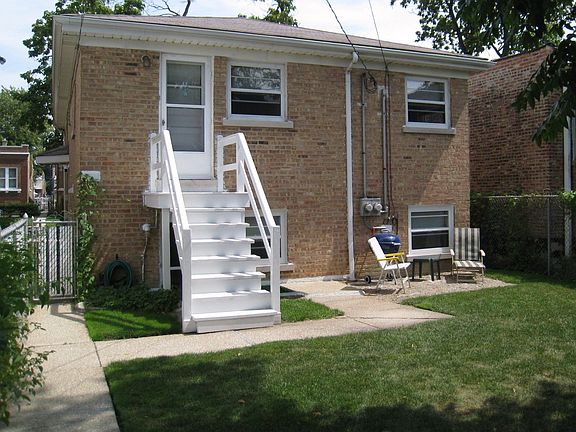 Rear view of house from sidewalk.