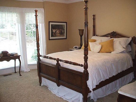 Large master bedroom with bay window and fresh paint