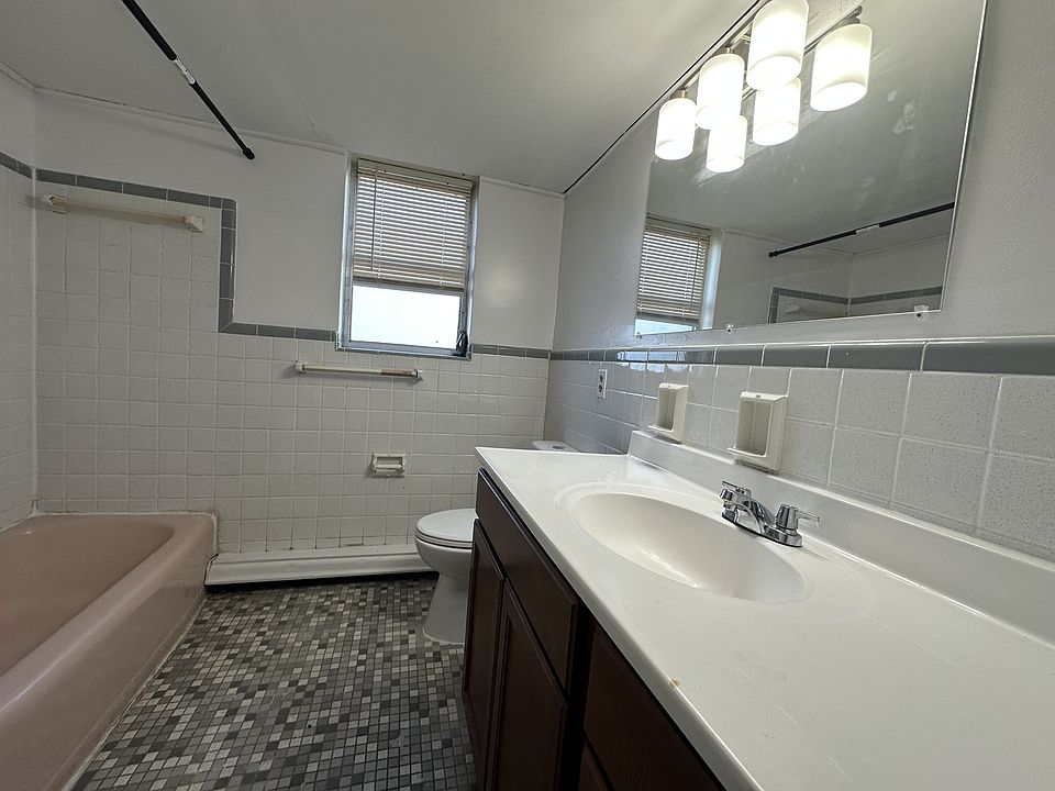 Freshen up in your large, updated, neutral bathroom with extra countertop for all your personal care