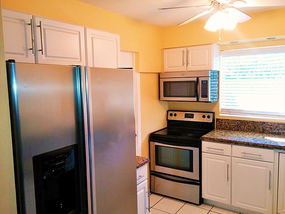 Double door Refrigerator with Ice and Water in the Door. Smooth Top Range and Microwave