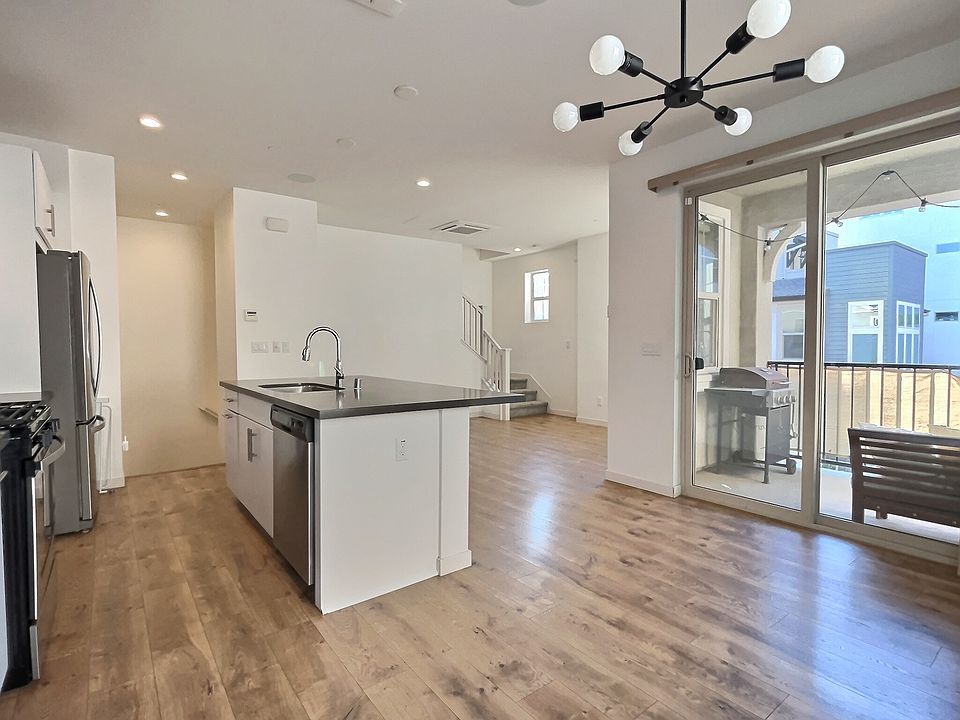 Open living area with modern kitchen and large island.