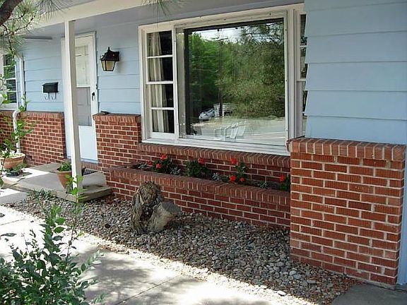 Front of home with brick planter.