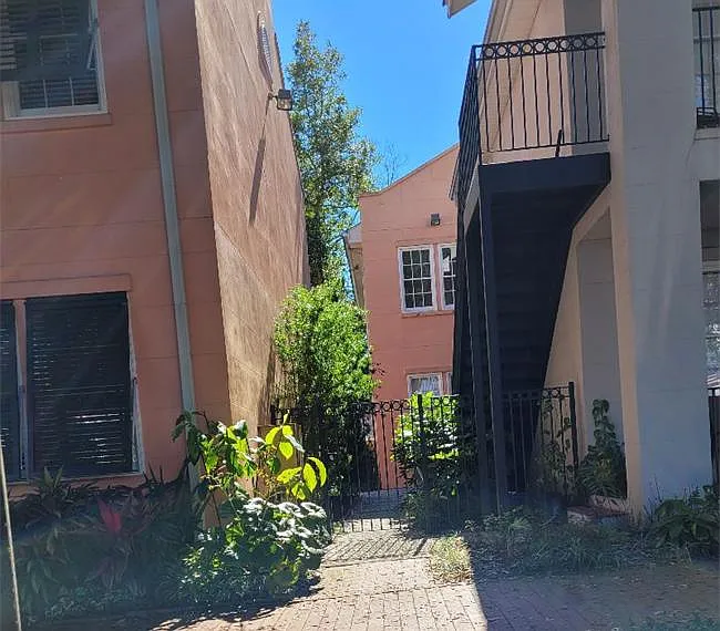 Upstairs in pink bldg behind the gate safe and secure,