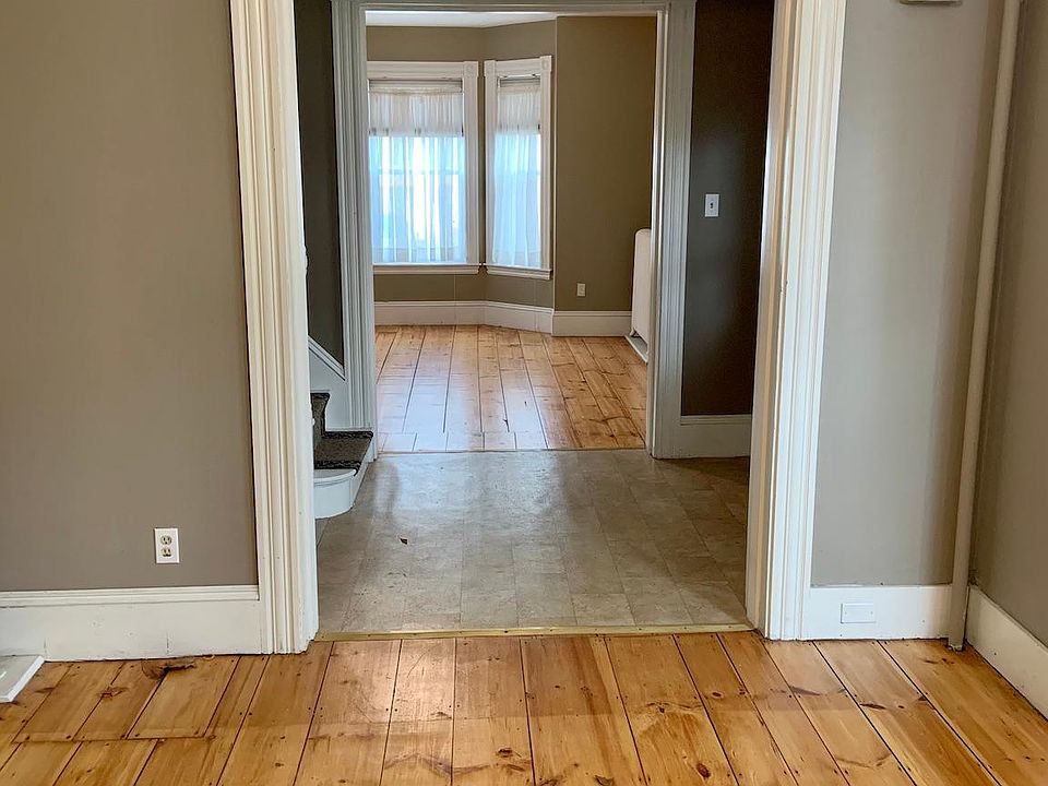 View from dining room through foyer/entry to house, to living room.