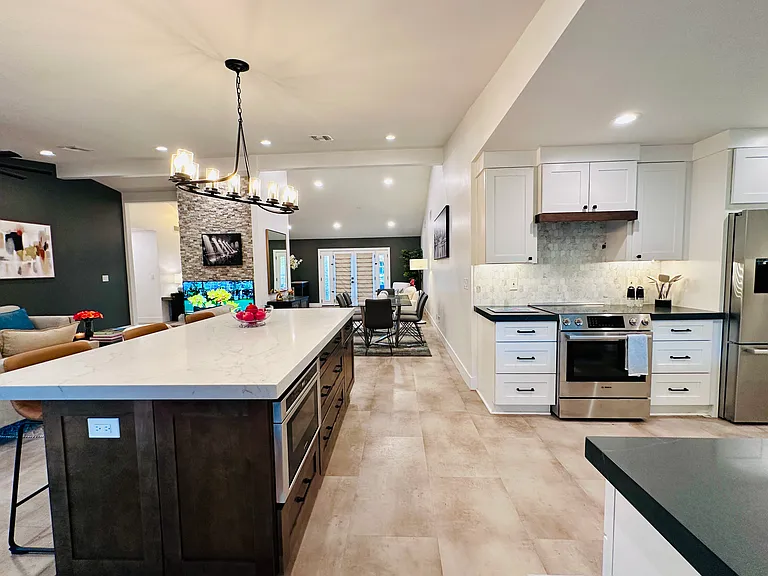 Chef's Kitchen: 
Fully equipped with everything you need to prepare a nice meal, featuring quartz countertops, a coffee maker, and a massive center island perfect for meal prep and casual entertaining.
