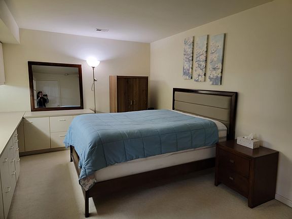 Bedroom with comfortable queen size bed with build in office