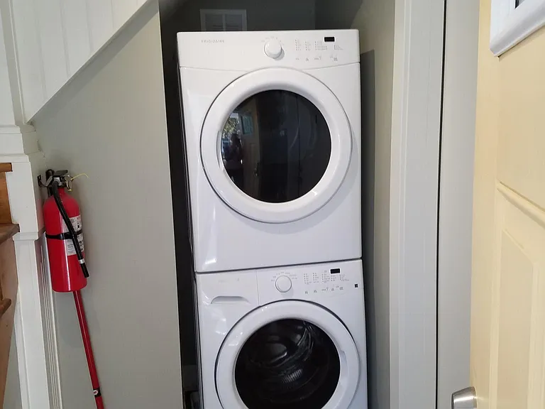 Front door entry way with shared washer and dryer. Step to go up to the apartment are on the left. (not in photo)